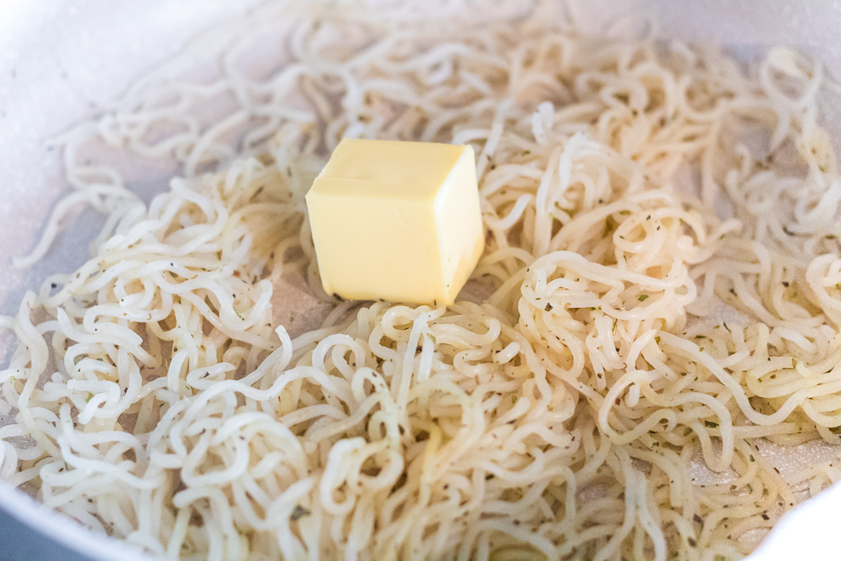 shirataki noodles in a skillet with butter