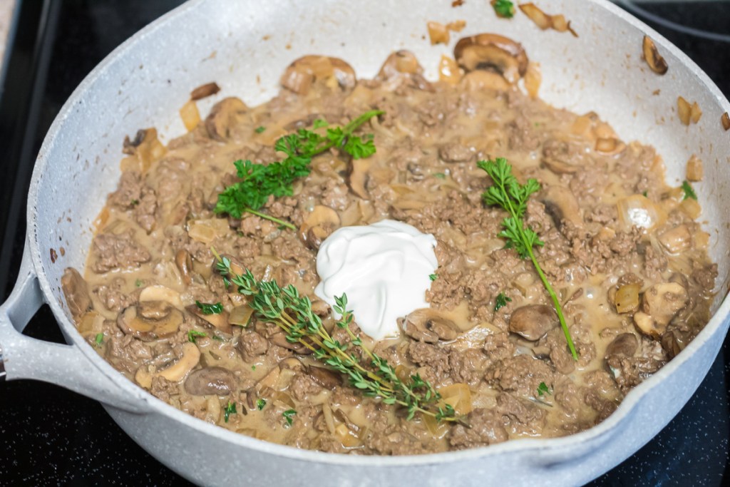pan of beef stroganoff with a dollop of sour cream