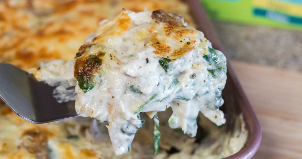 scooping up keto chicken lasagna with spatula 