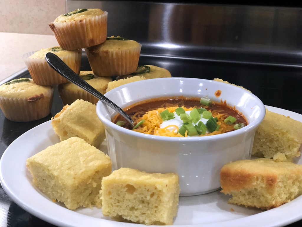 Keto cornbread muffins and pieces with chili