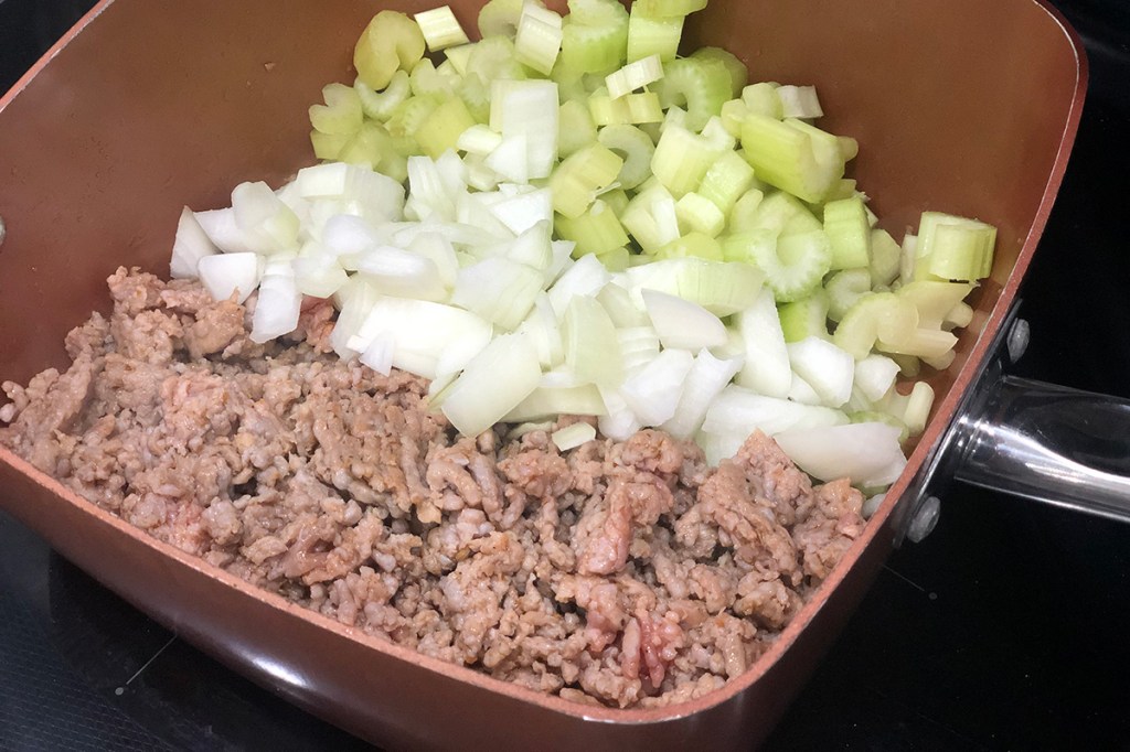 Sauté pan with ground sausage, onion, and celery