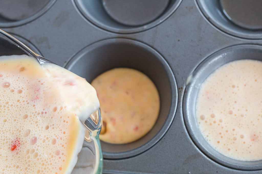pouring egg bites into muffin tin
