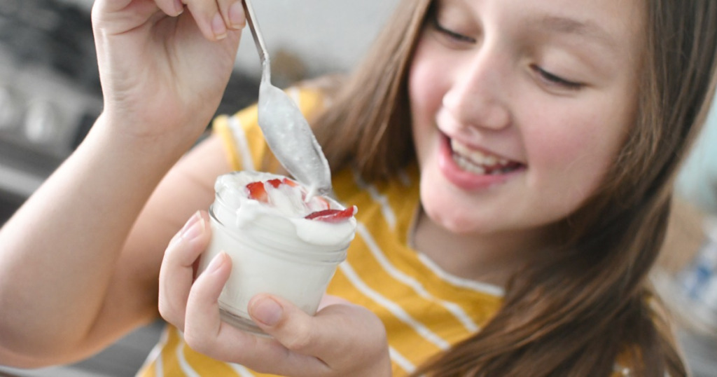 girl holding jar with snack