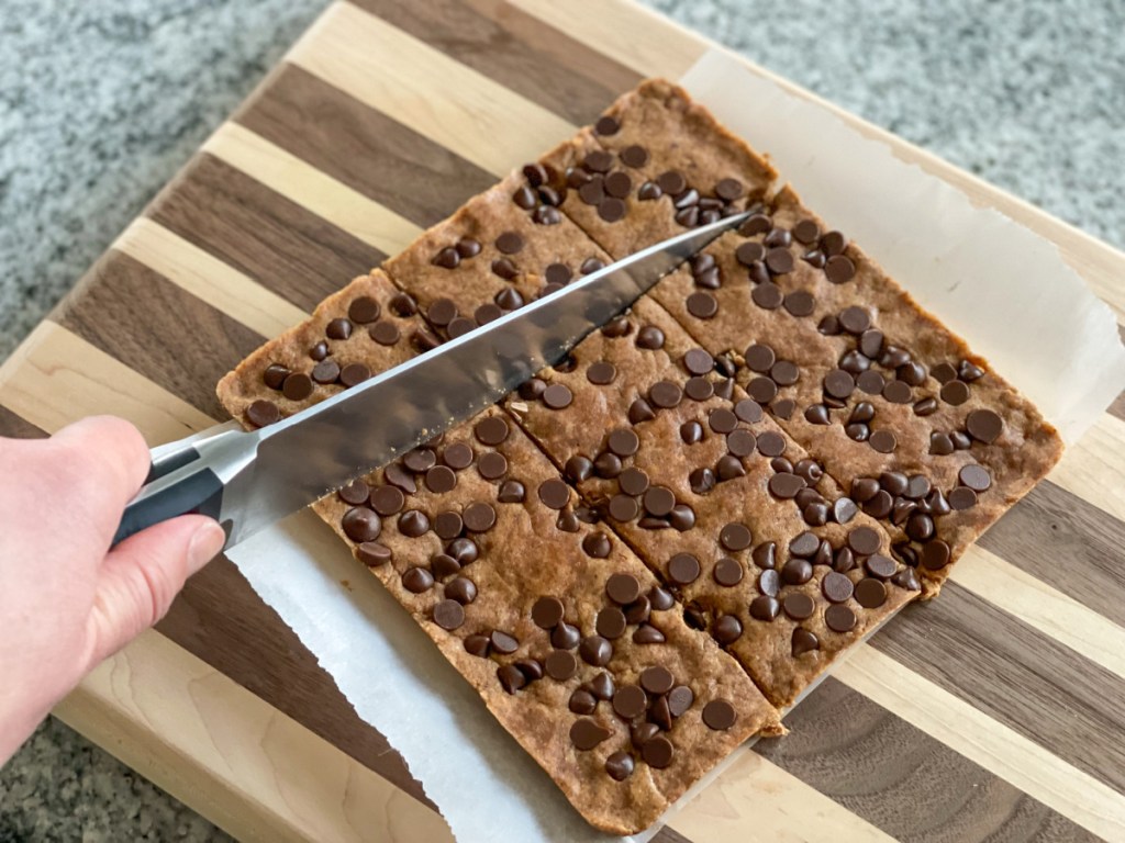 slicing cookie dough protein bars
