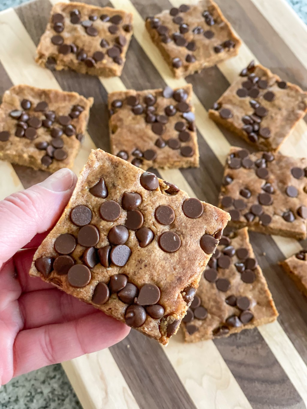 holding a cookie dough protein bar