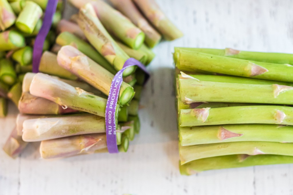 cutting against the band of asparagus stalks