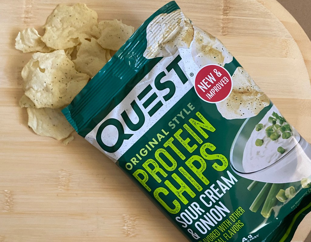 Bag of Quest Protein Chips Sour Cream on cutting board 