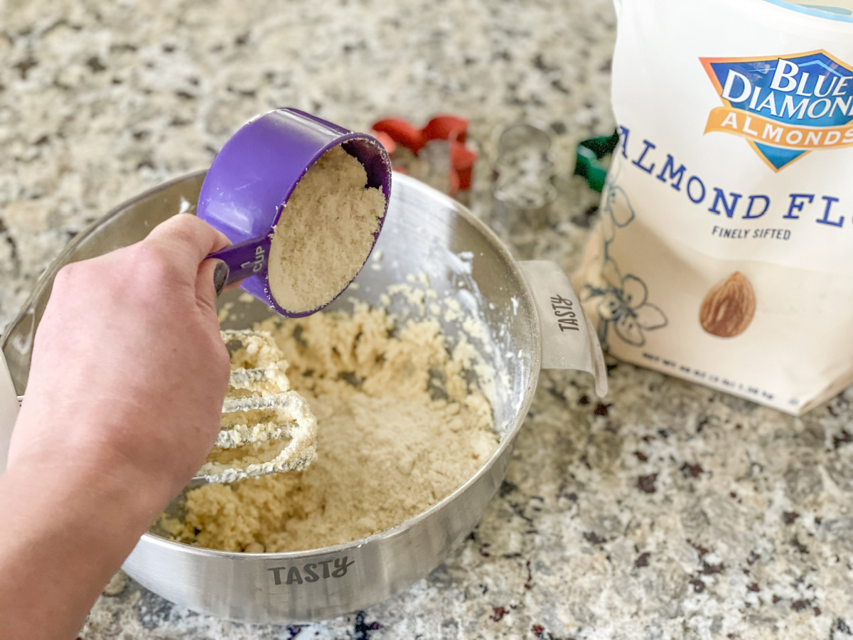 adding almond flour to soft keto sugar cookie batter