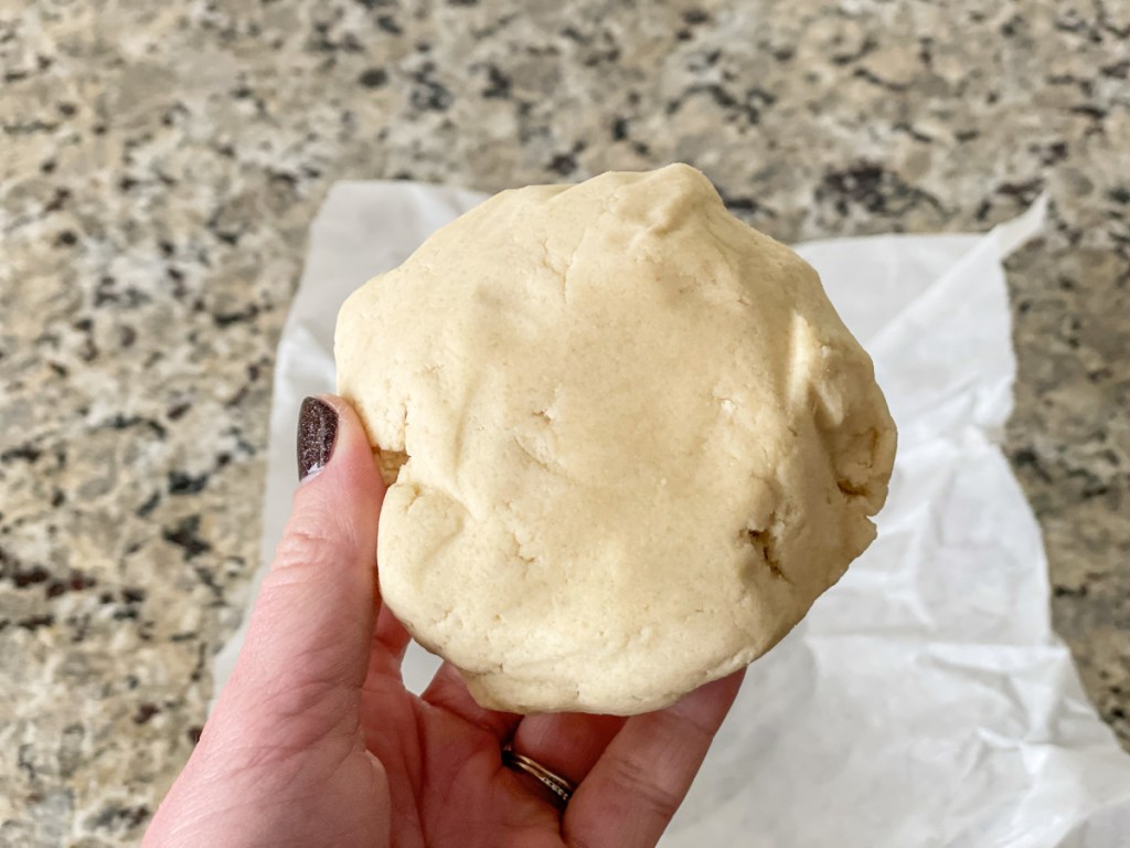 holding keto sugar cookie dough ball 