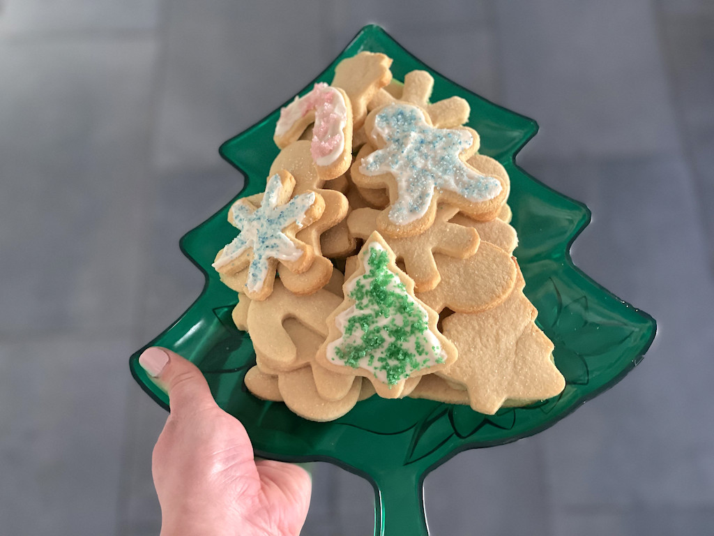 holding tray of Christmas keto sugar cookies 