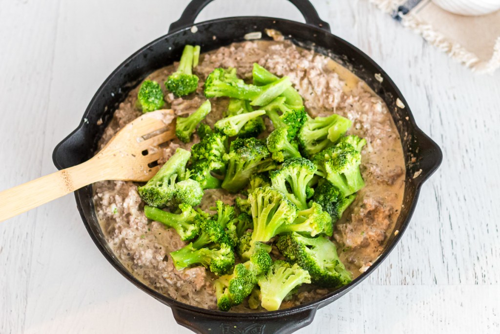 stirring in broccoli in the casserole