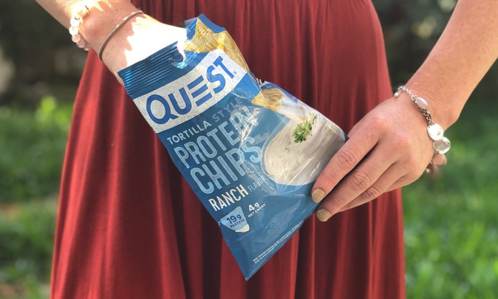 woman holding a bag of quest ranch protein chips