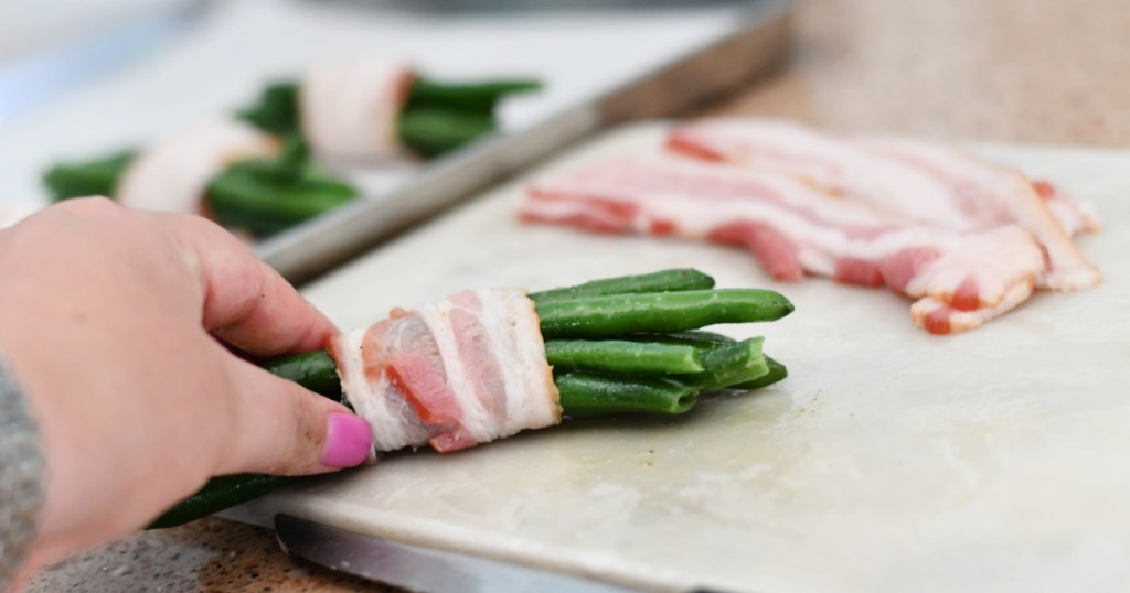 rolling green beans in bacon