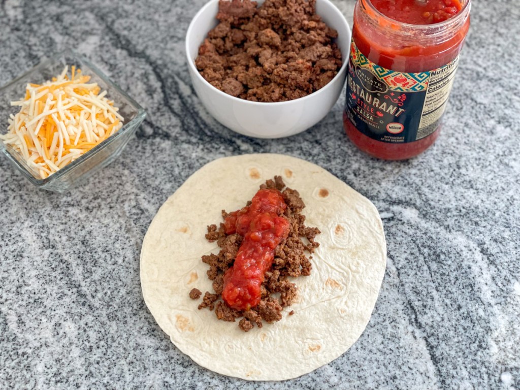 ground beef and salsa on a tortilla