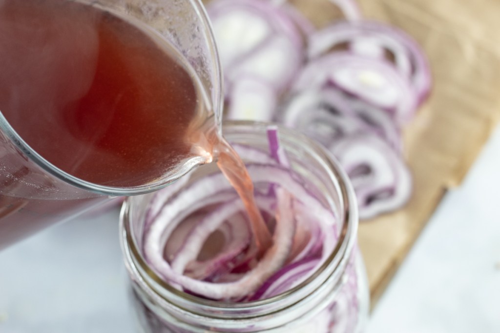 adding red wine vinegar to red onions