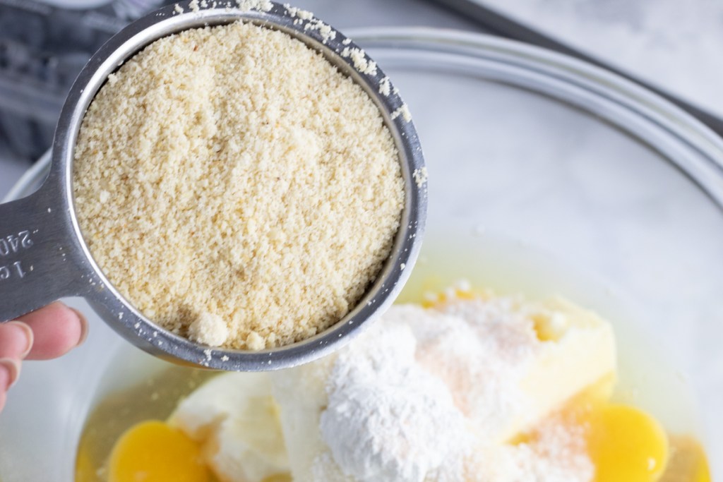 pouring almond flour into mix