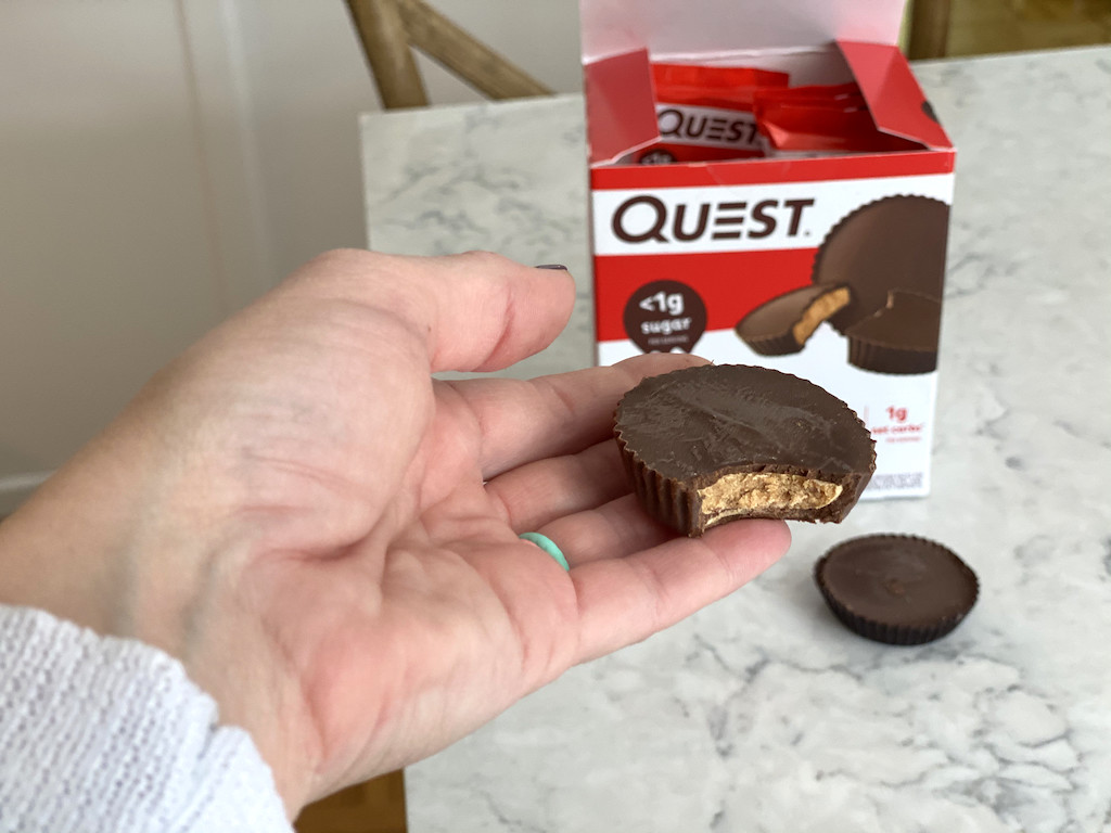 holding Quest peanut butter cups 