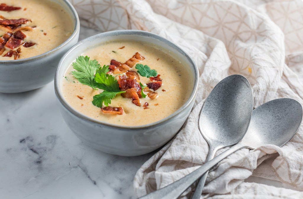 jalapeno popper soup in bowl on table