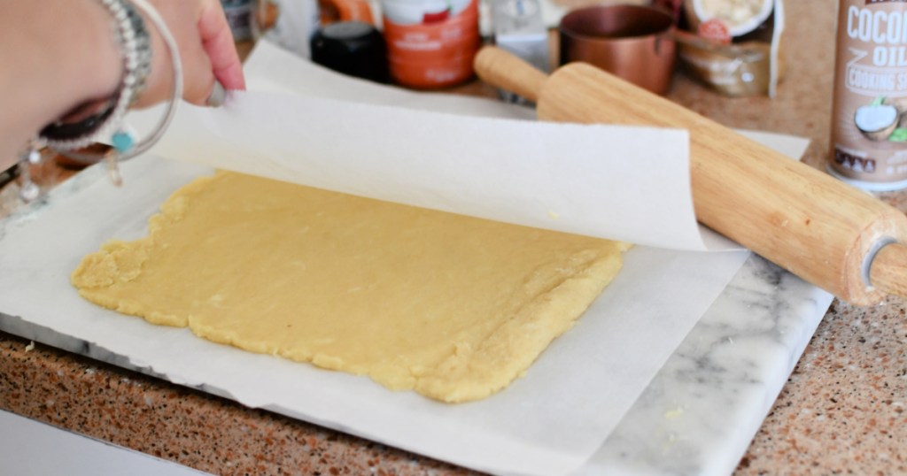 rolling dough between parchment paper