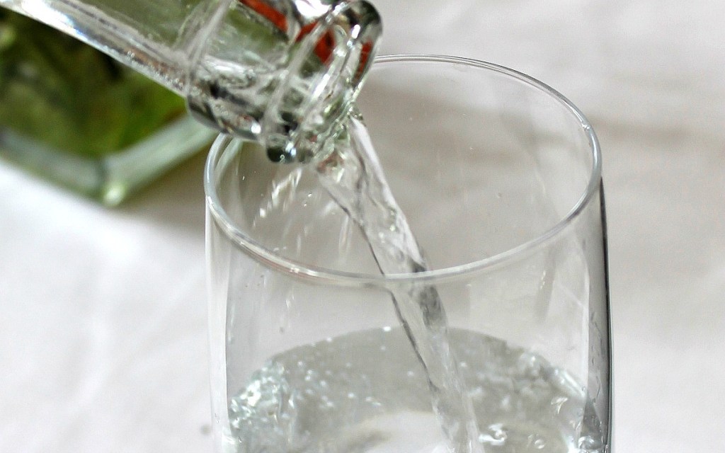 bottle pouring water in glass