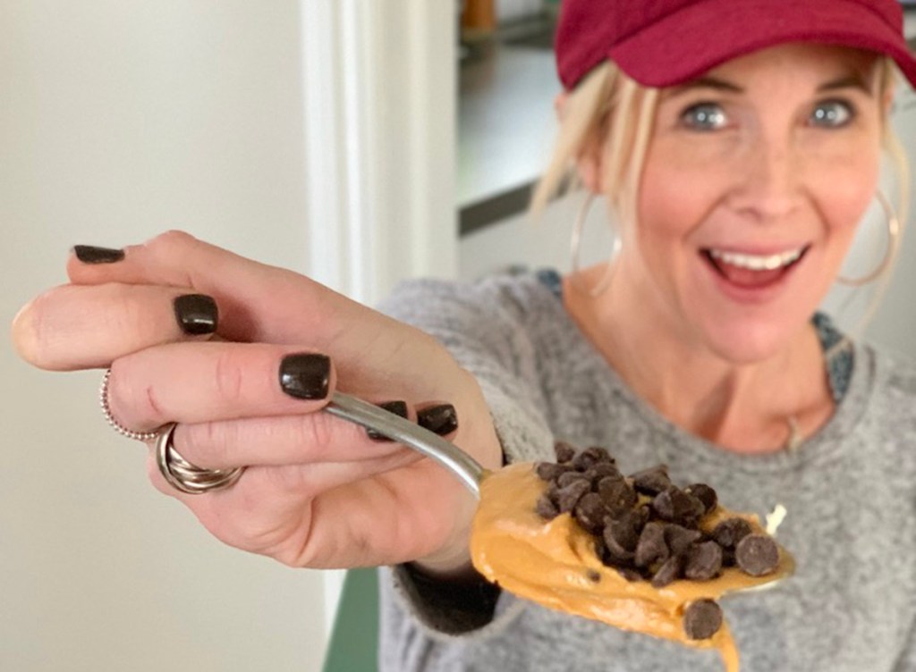 woman holding spoon with peanutbutter