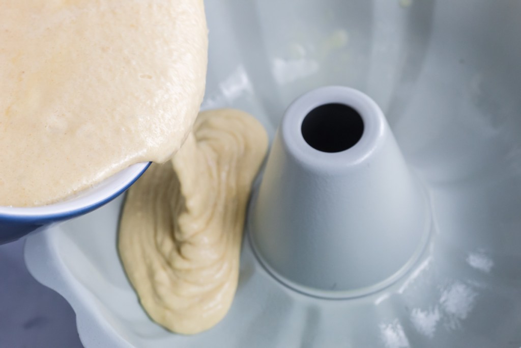 pouring batter into bundt cake pan