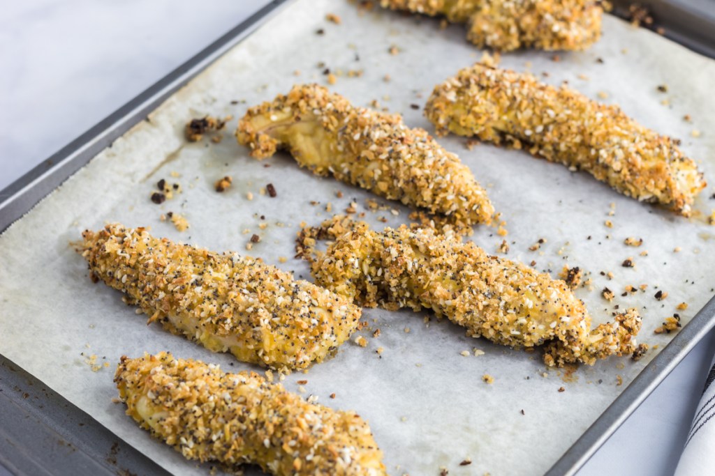 baking chicken strips on a baking sheet