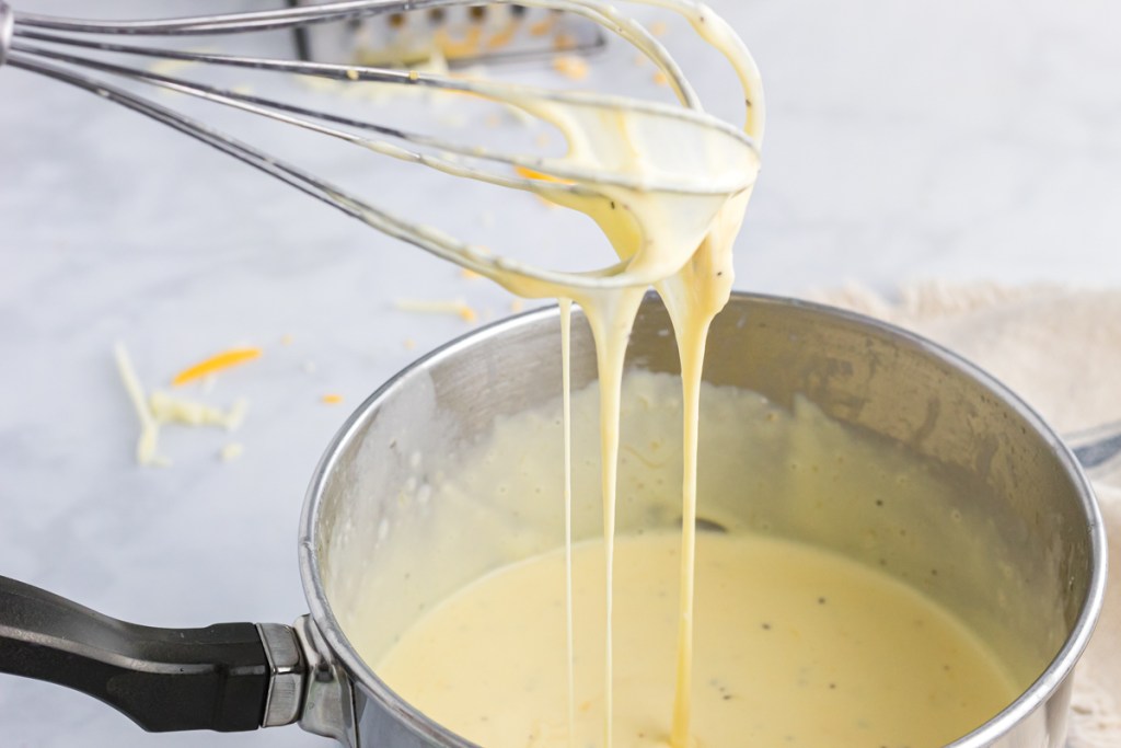 whisking cheese sauce