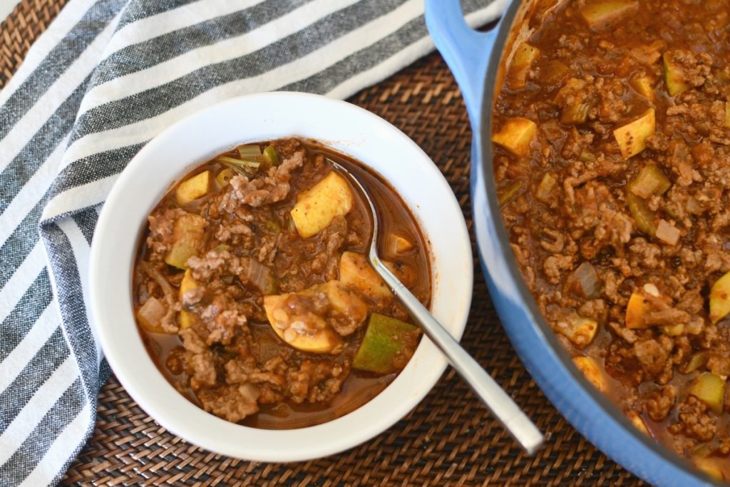 bowl of keto goulash next to pot of goulash