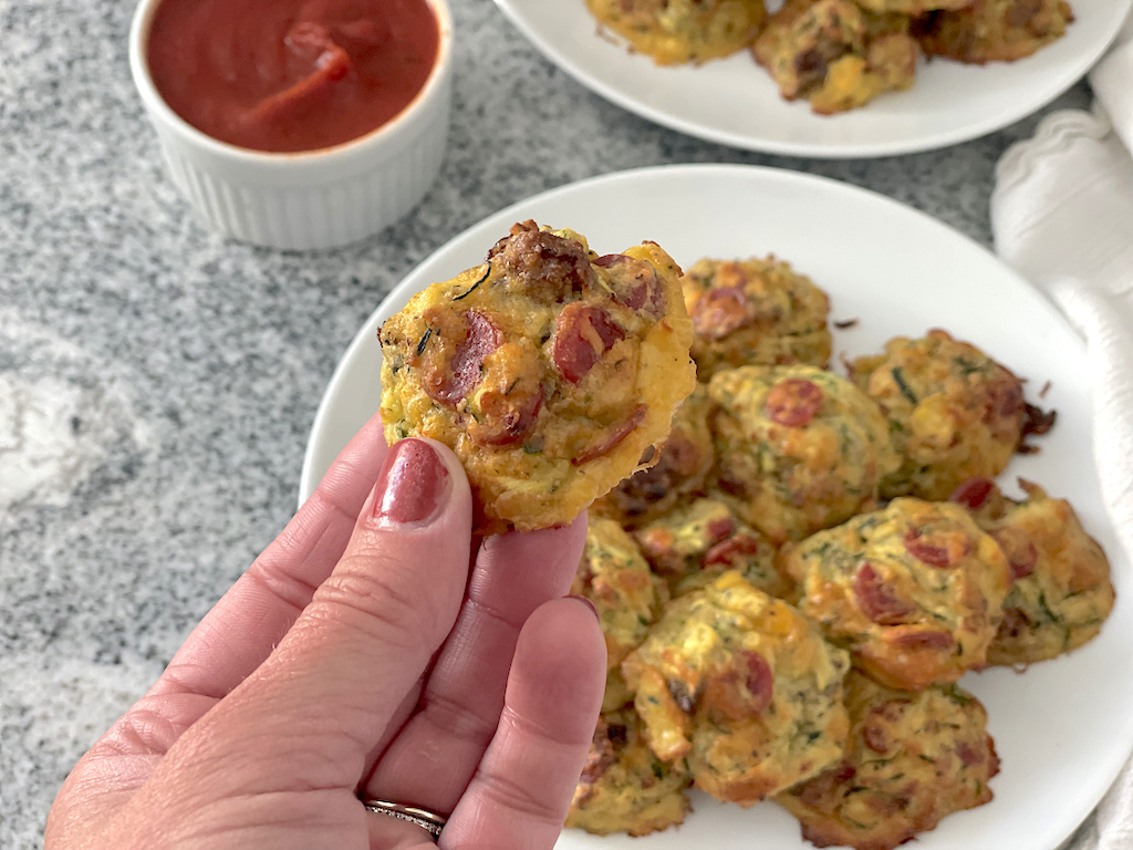 holding zucchini pizza bite 