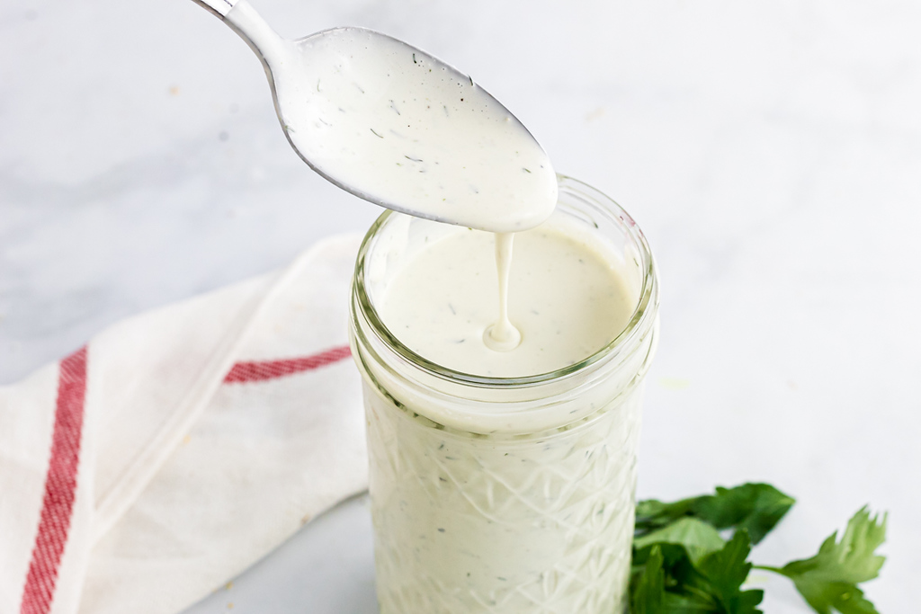 Spoon with keto ranch dressing on it 