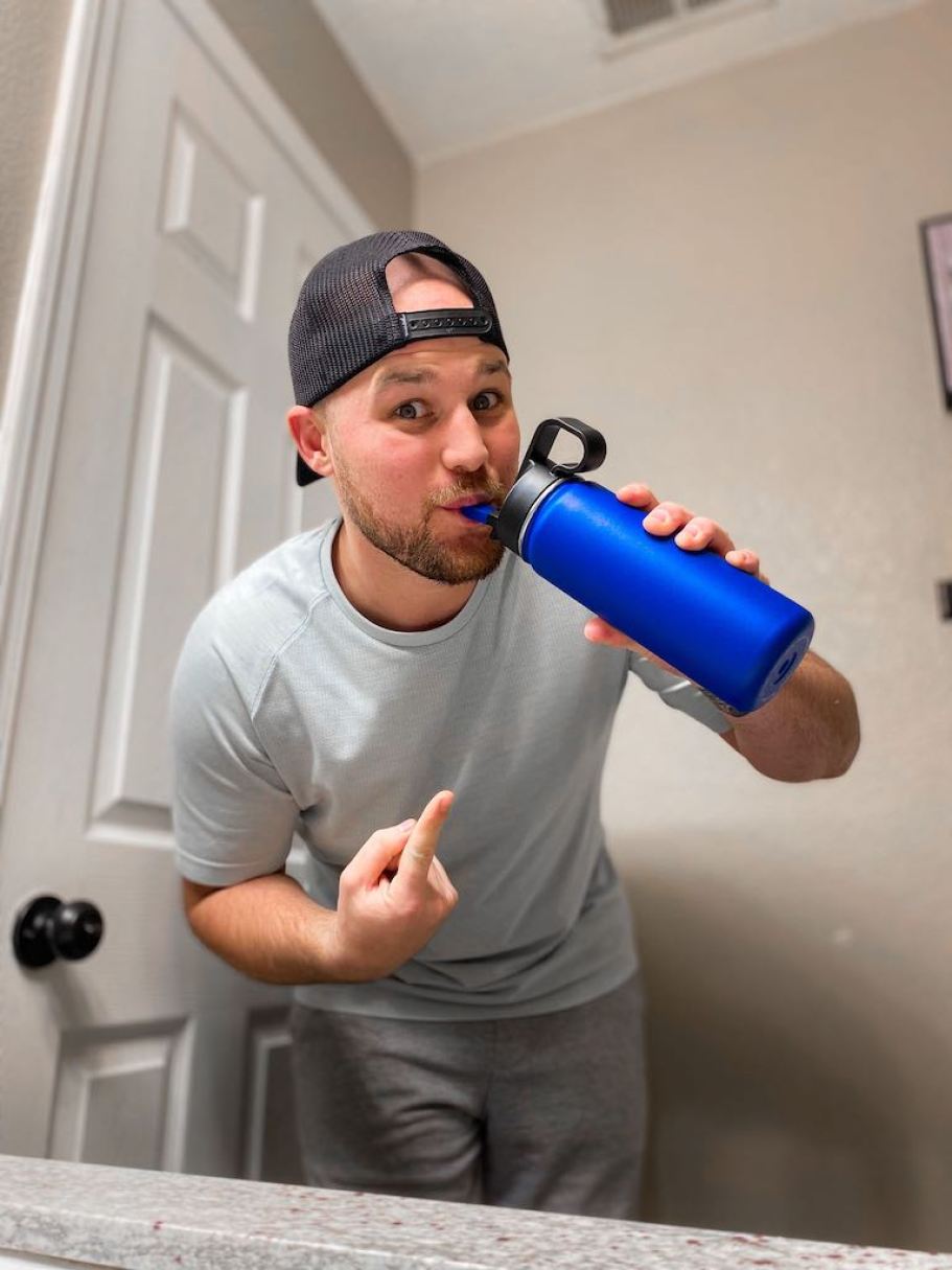 man drinking blue water bottle 