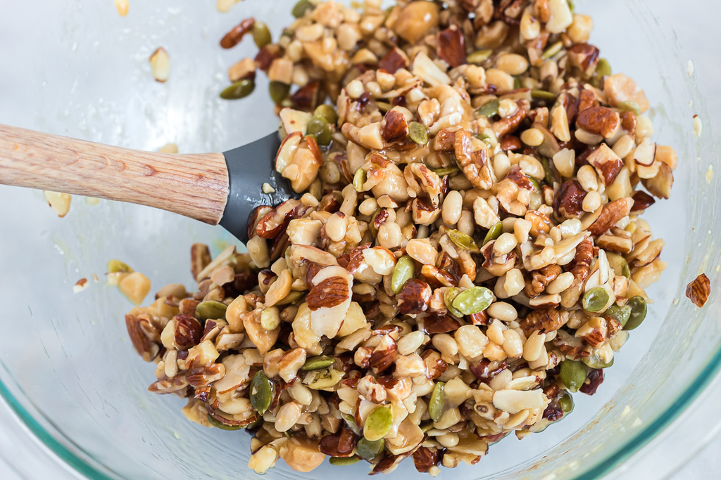 mixing keto trail mix in bowl 