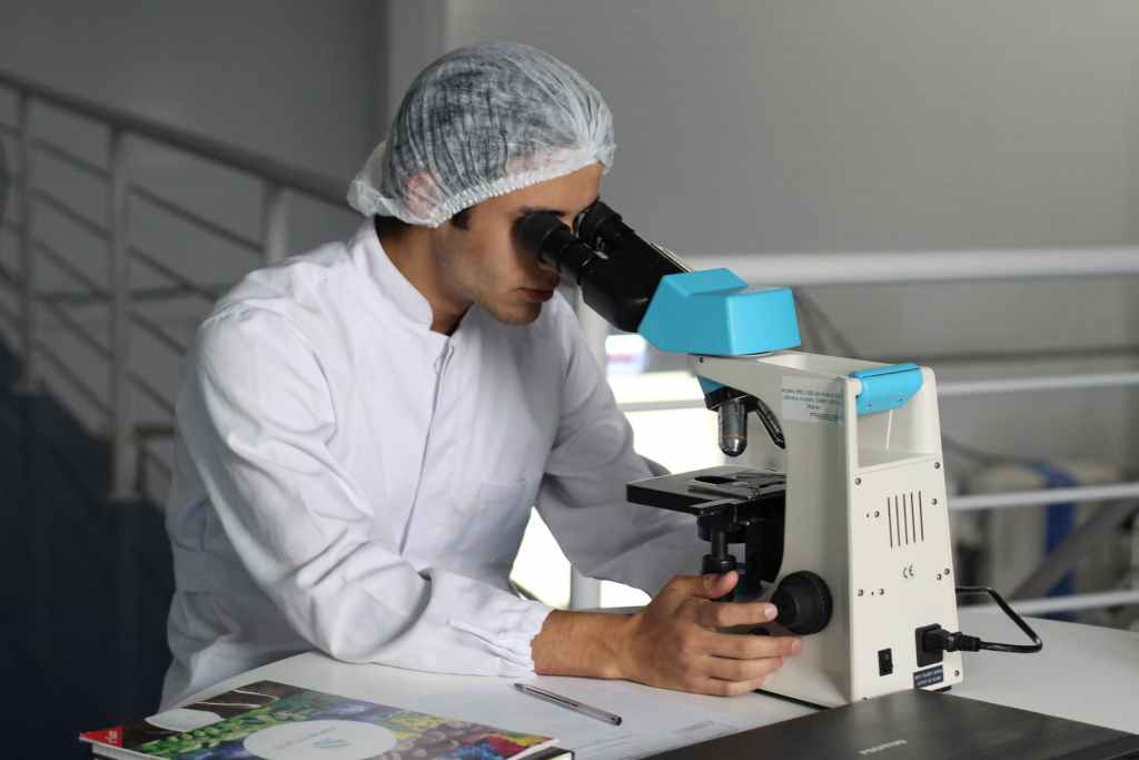 scientist looking at dna on microscope