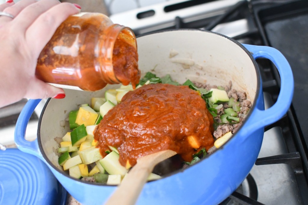 pouring marinara in goulash
