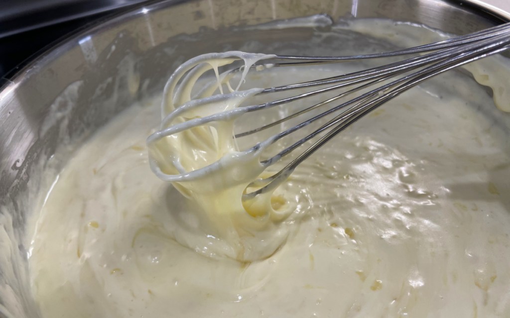 whisking queso in pan