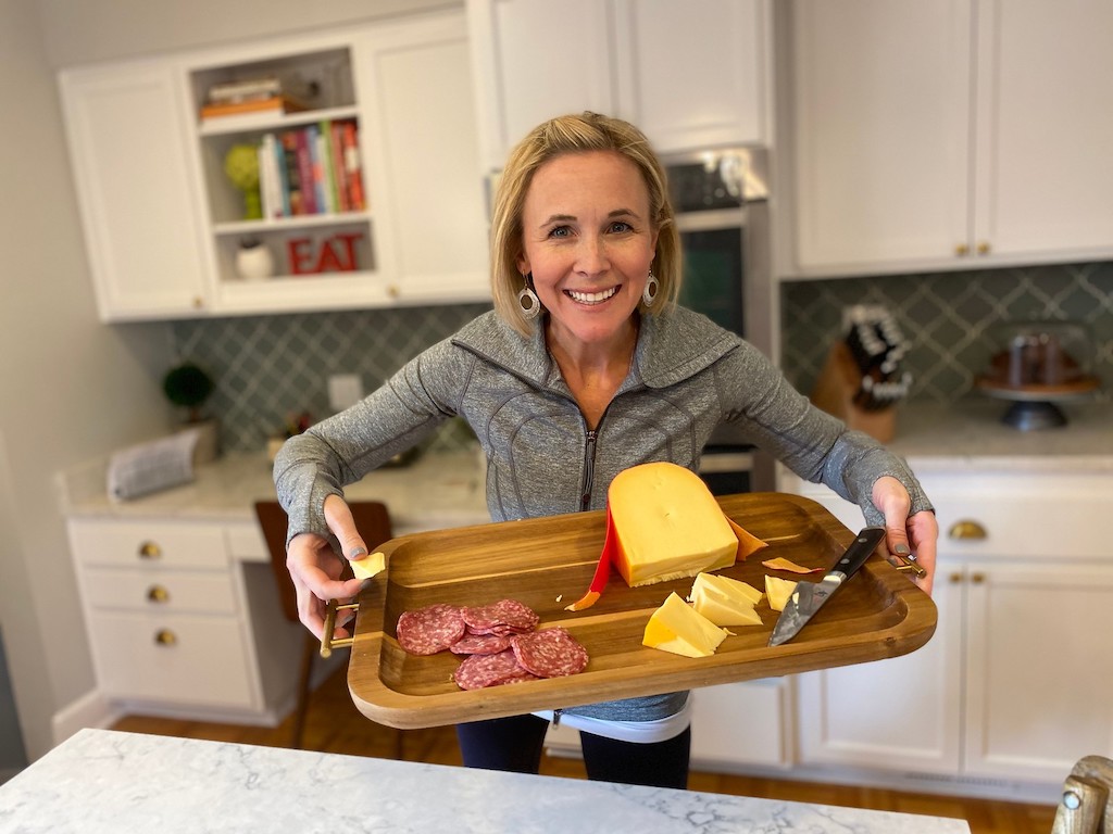 woman holding tray of keto foods