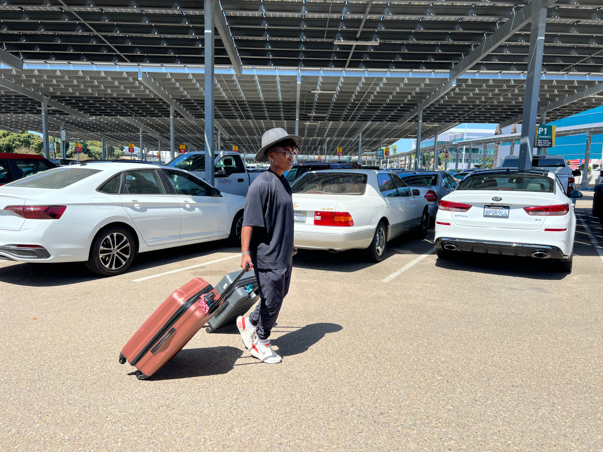 Woman walking through a parking lot airport