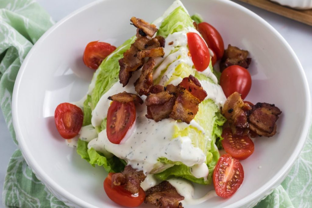 adding toppings to salad wedge