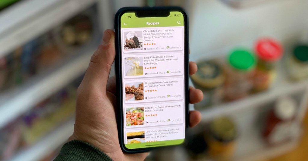 holding iPhone with Hip2Keto app and recipes on the screen