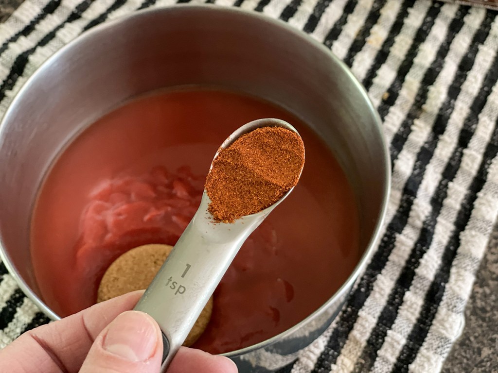 adding paprika to a sauce pan