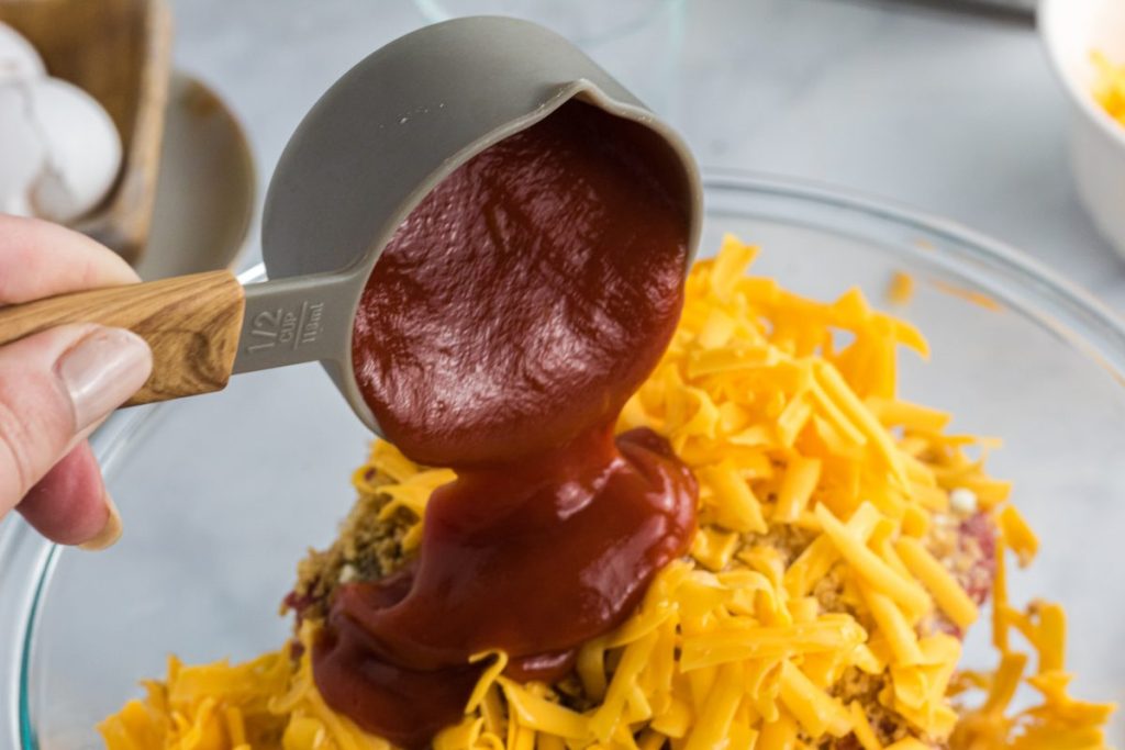 sugar-free ketchup pouring into meatloaf