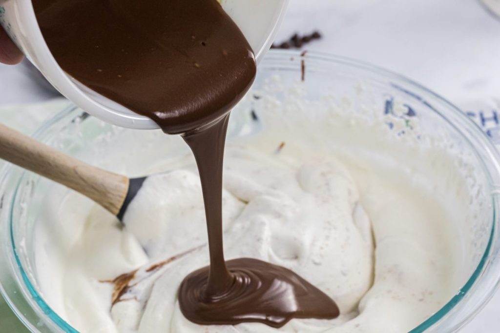pouring chocolate into whipping cream