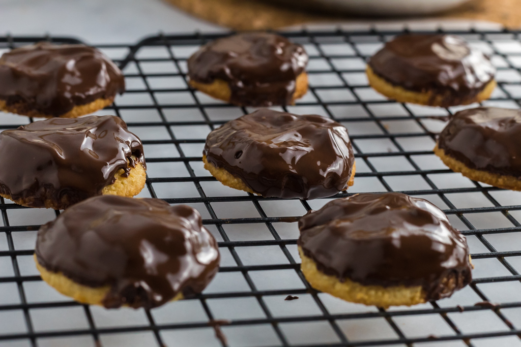 keto tag along cookies with melted chocolate on cooling rack 