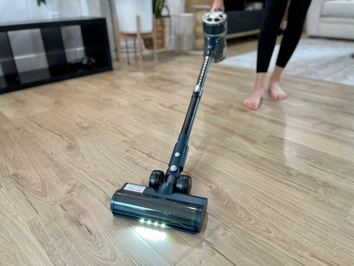 A woman vacuuming, one of the easy ways to exercise