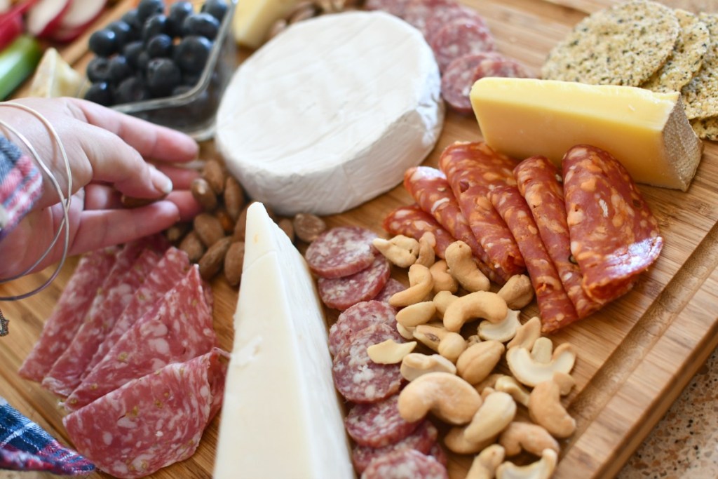 adding nuts to a cheese board