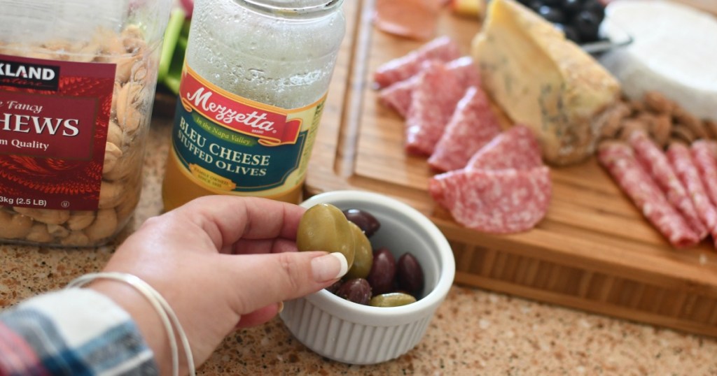 adding olives to charcuterie