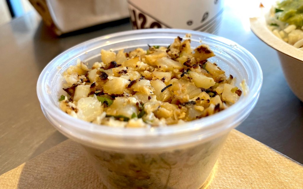 plastic cup of cauliflower rice on table