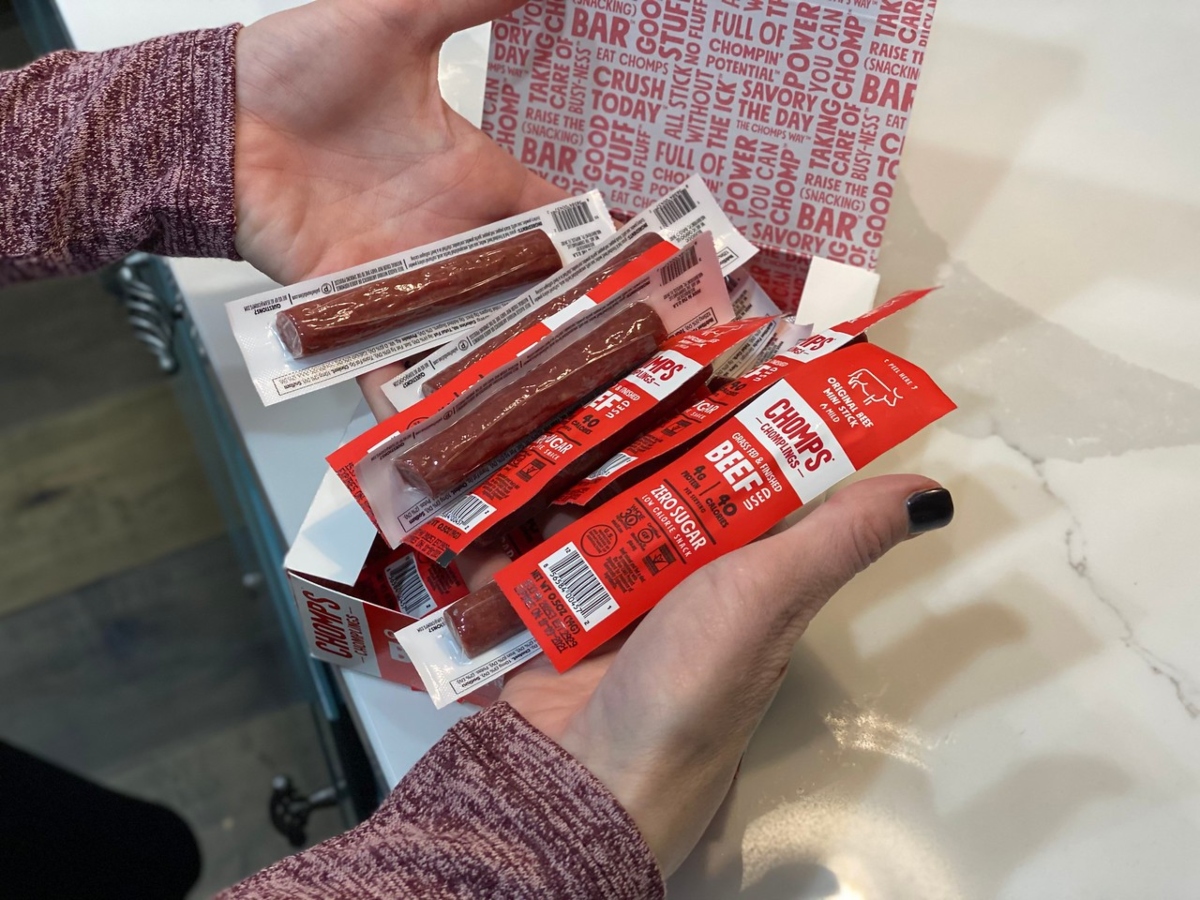 holding Chomps Chomplings beef sticks
