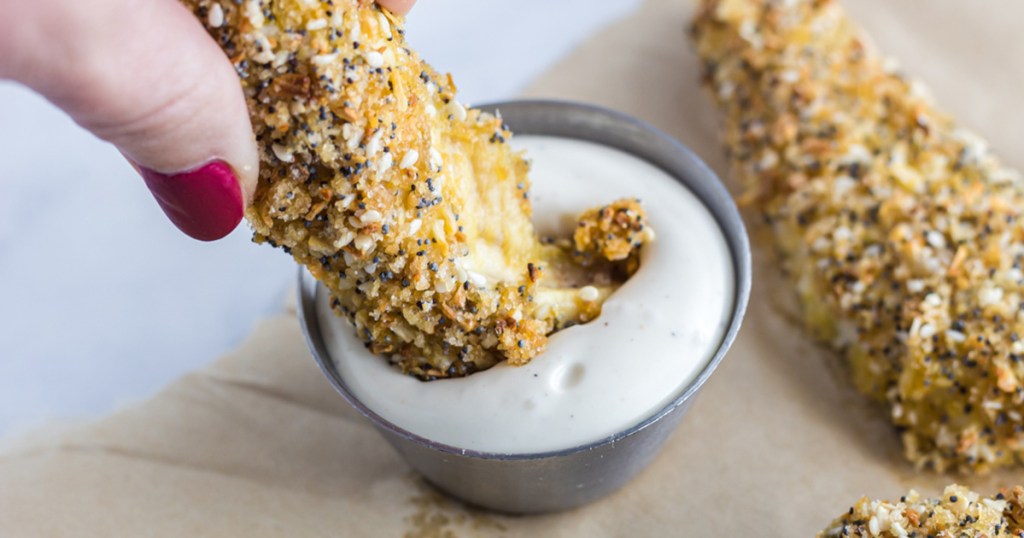 dipping everything bagel chicken tender into keto ranch